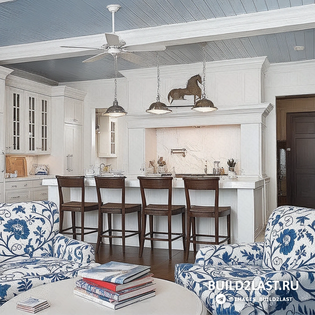 Современная кухня в белом цвете с французским дизайном, реечным потолком, синий акцент и кухонным островом.